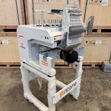 Ricoma marquee 1501 machine in a warehouse setting with wooden pallets in the background